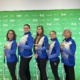 Women's curling team poses with brooms at 2023 Canada Winter Games