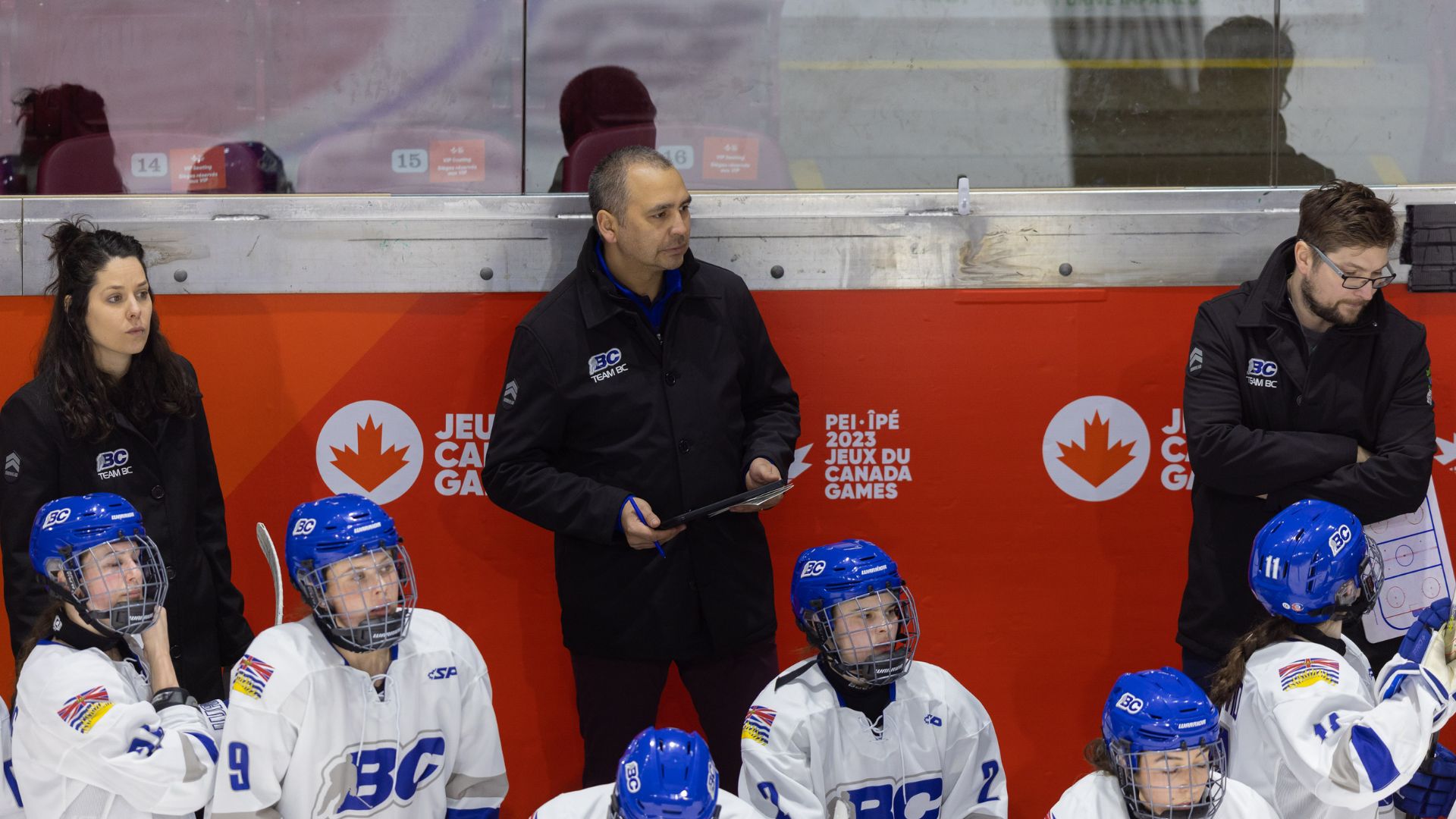 Holmes coaches on the bench during a Game