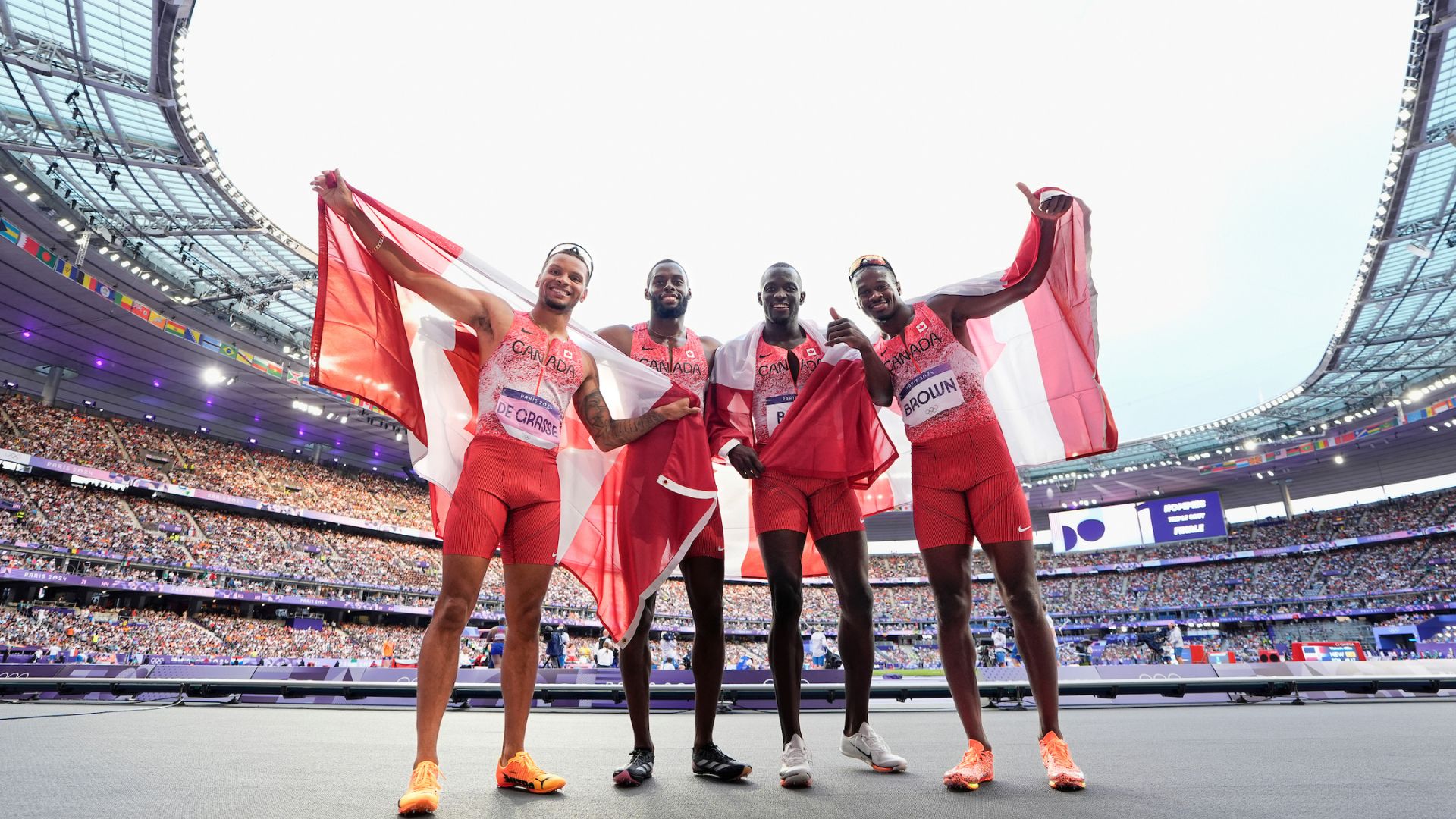 Canadian men's 4x100 metre team poses after winning gold at the Paris Summer Olympic Games.