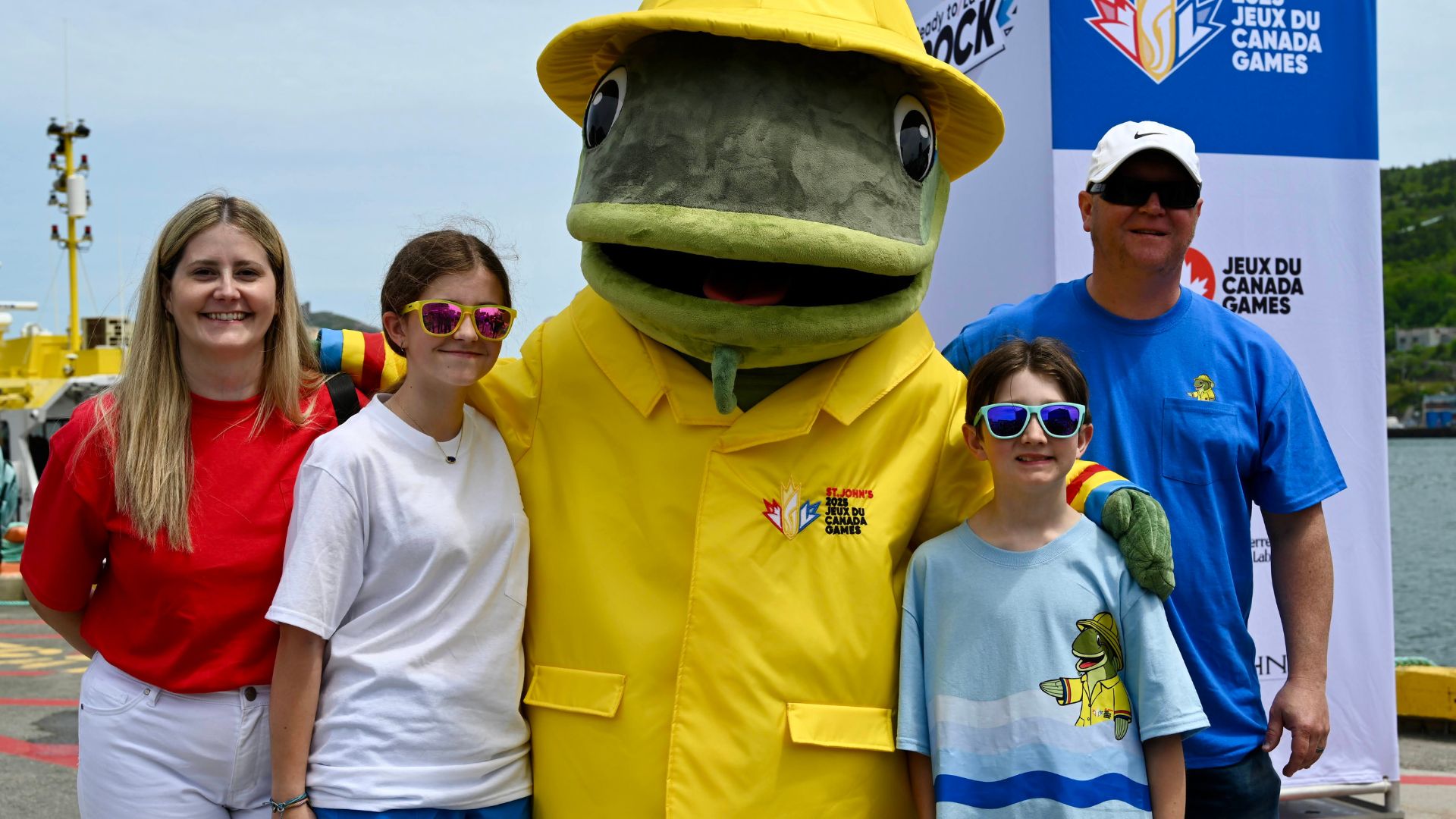 2025 Canada Summer Games mascot Gusty poses with creator and his family