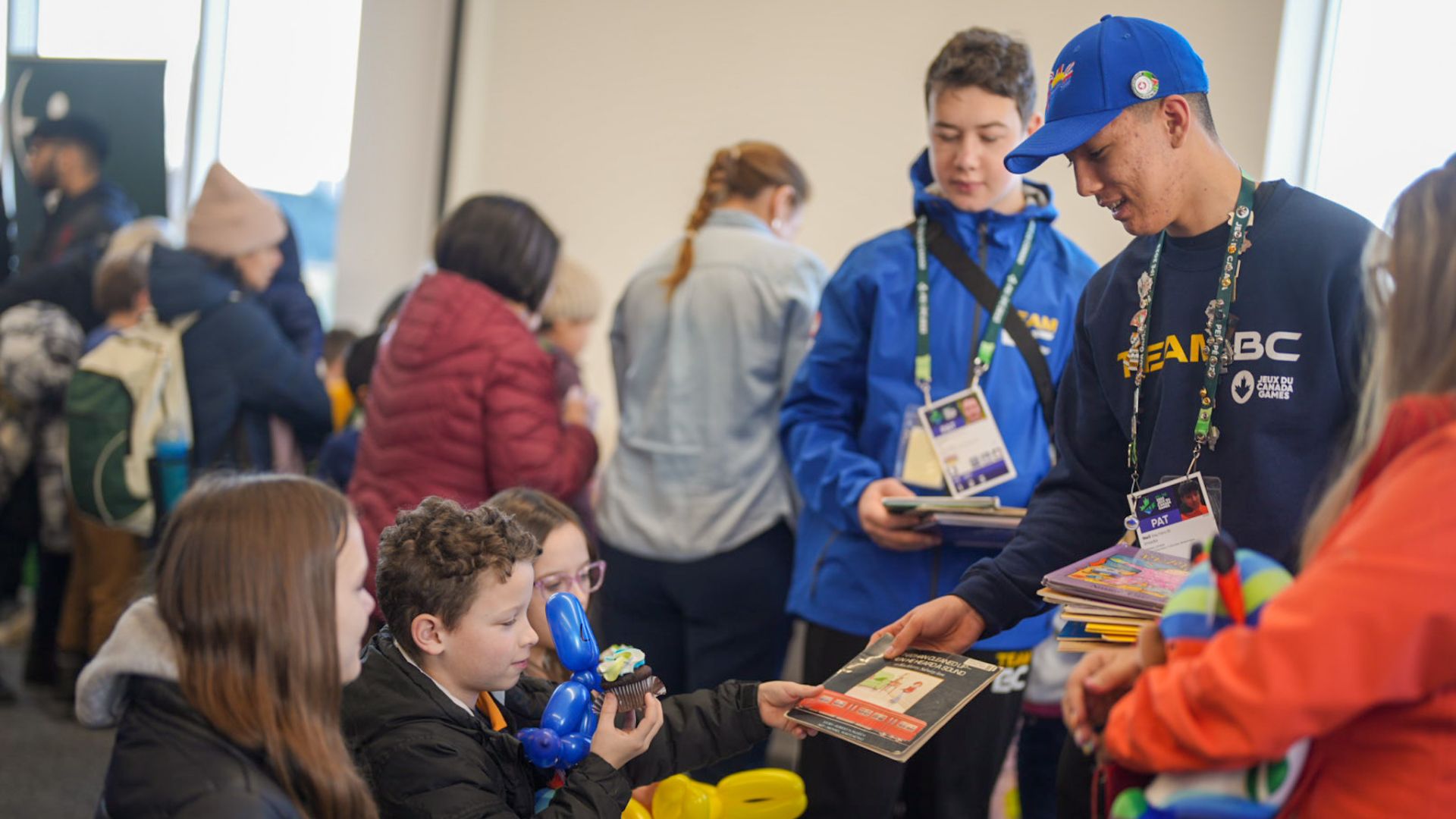 Team BC athlete hands out books to children at Canada Games