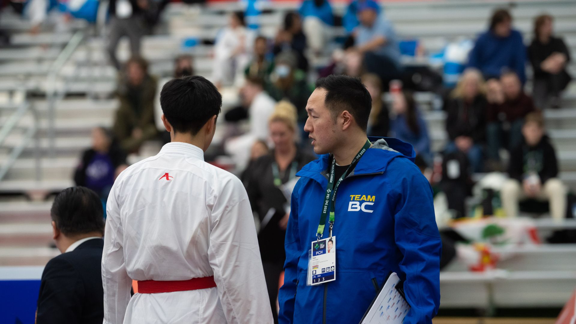 Coach talks to Karate athlete