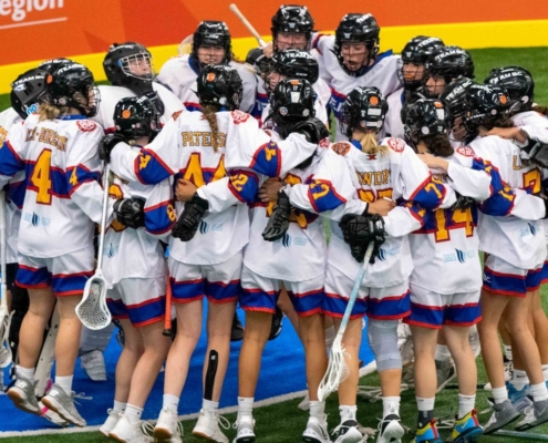 Team BC girls lacrosse team comes together in a huddle at the Canada Games.
